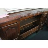 *A French chestnut side cupboard, 19th century with an open shelf to the middle flanked by