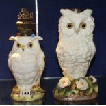 Two 19th century porcelain owl oil lamps, with glass eyes, one perched on a flower encrusted base