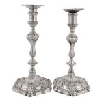 A matched pair of George III cast silver hexagonal candlesticks  A matched pair of George III cast