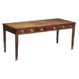 A George III mahogany library table, circa 1800 the top with inset tooled...  A George III