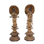A pair of South East Asian carved giltwood models of Dieties, 56cm high  A pair of South East