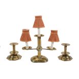 A Continental repousse brass three light candelabrum  A Continental repousse brass three light