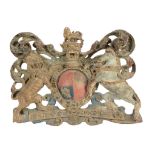 A George III carved, polychrome and parcel giltwood wall mounting armorial  A George III carved,