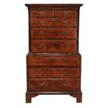 A George II walnut and featherbanded chest on chest, circa 1740  A George II walnut and