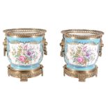 A pair of modern Sevres-style porcelain gilt-metal-mounted jardinieres in...  A pair of modern