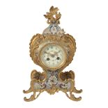 A French gilt brass and champleve enamelled mantel clock in the Louis XV...  A French gilt brass and