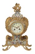 A French gilt brass and champleve enamelled mantel clock in the Louis XV...  A French gilt brass and