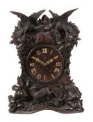 A rare Black Forest carved wood quarter-striking cuckoo table clock...  A rare Black Forest carved