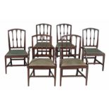 A set of six late George III mahogany dining chairs, circa 1800, to include two carvers, each with