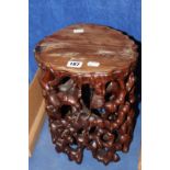 A Chinese hardwood carved stool, naturalistic relief of squirrels in woodland, 30cm high