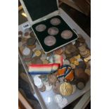 Two stamp albums of Worldwide stamps, medals, commemorative coins and assorted foreign coins etc