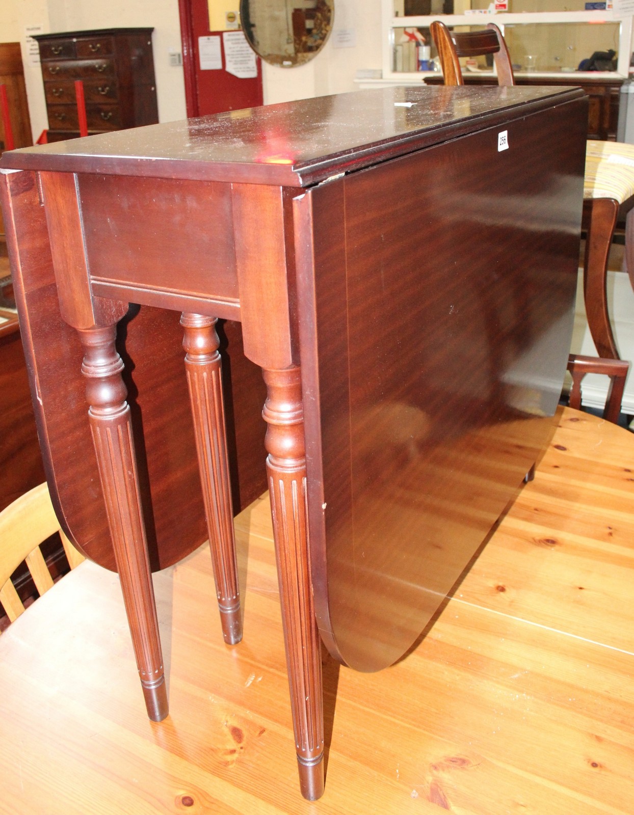 A Regency style mahogany gateleg table and six matching chairs Best Bid