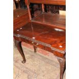 A George III style mahogany card table, with carved edge and on cabriole legs with ball and claw