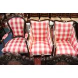 A pair of early 20th Century armchairs, each upholstered in red and white check, together with a