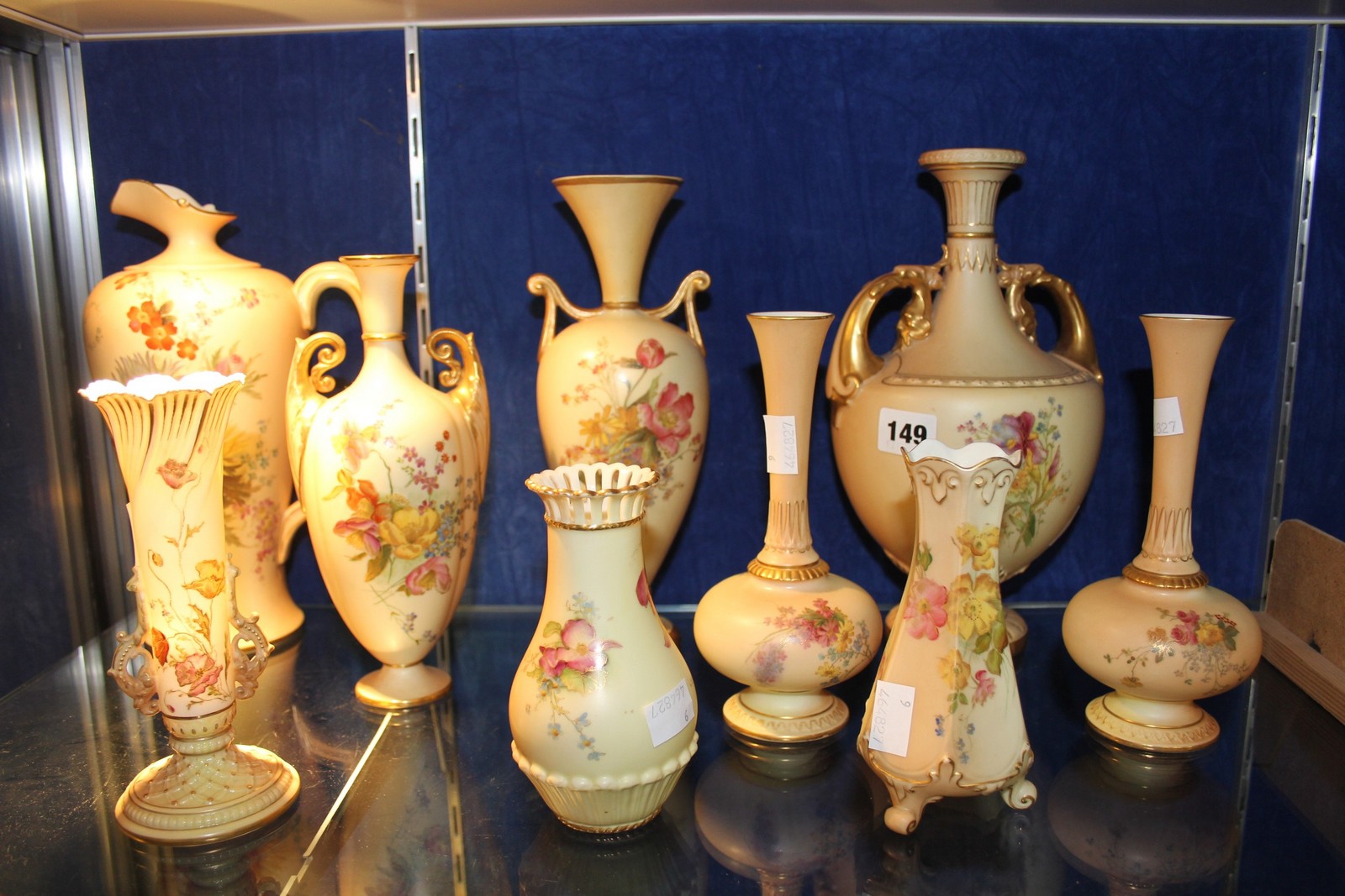 A selection of Royal Worcester ivory-ground porcelain, including ewers and vases decorated with