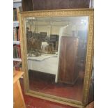 A gilt composition framed rectangular wall mirror, probably early 20th century, with bevelled