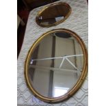 A giltwood framed oval wall mirror, late 19th century 99cm high, 82cm wide and another similar