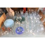 An assortment of glassware to include wines, vases, decanter stoppers and a colour print of still