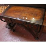 A Queen Anne style walnut dressing table with three drawers on cabriole legs with shell carved knees