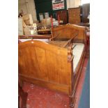 A French oak bed, with arched ends 111cm high, 210cm wide to include mattress 180 x 113cm