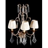A pair of Continental, probably Italian gilt wrought iron and glass mounted three light wall