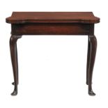 A George II mahogany folding tea table, circa 1740, the rectangular folding top with outswept