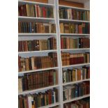 Fourteen shelves of books, leather bound, antiquarian and other hard cover books, including the