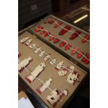 An early 20th Century Chinese red stained bone chess set in lacquered box (AF)