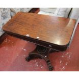 A Victorian plum pudding mahogany tea table with an acanthus carved turned stem on quadrapite base