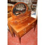 An Edwardian mahogany and crossbanded dressing chest with an oval mirror 104cm wide