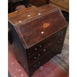 An Edwardian mahogany and inlaid bureau with three drawers