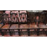 A set of six Victorian carved oak and canework dining chairs to include an armchair and five side