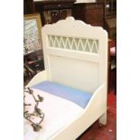 A single white painted bed frame with mattress base.