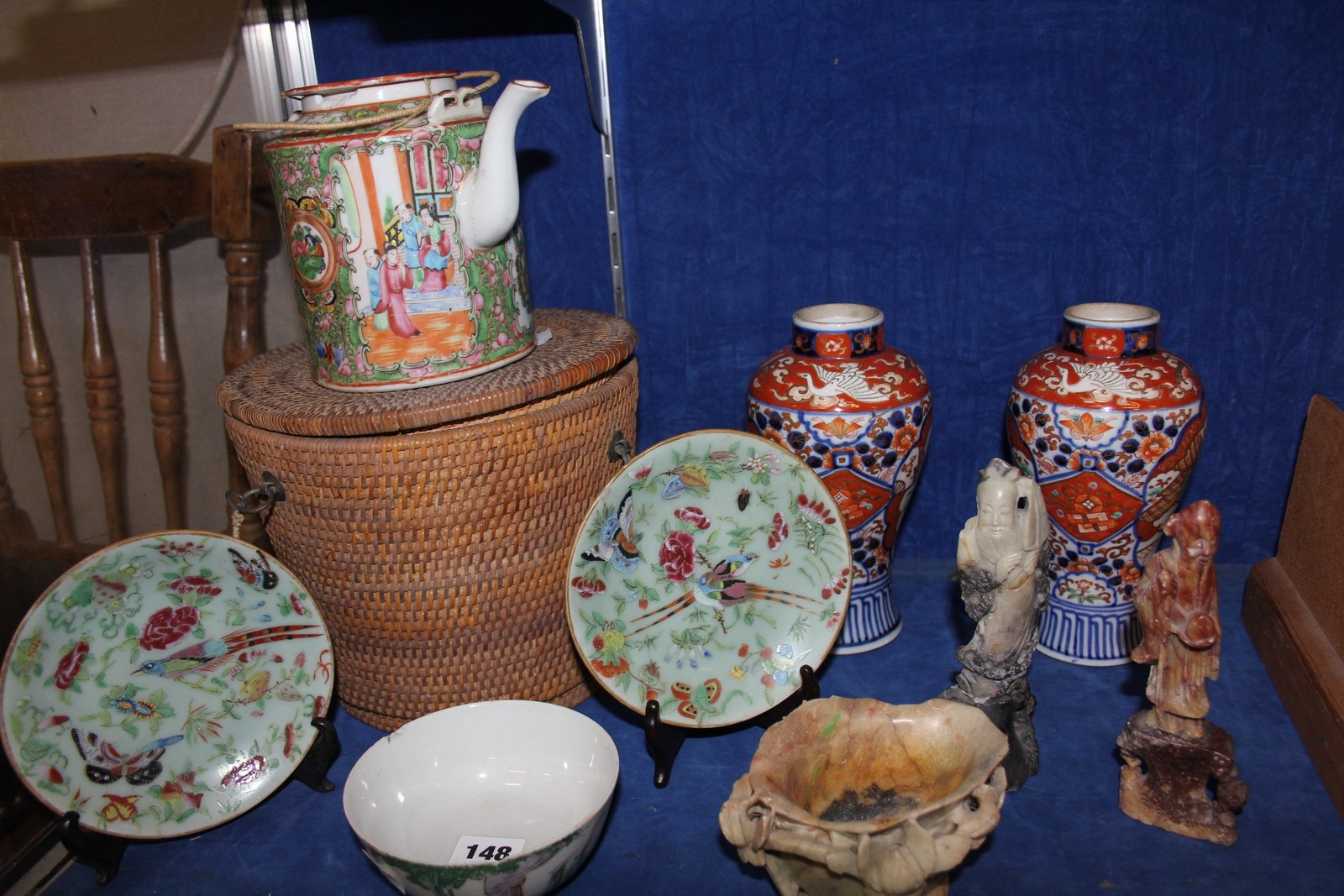 A pair of Japanese imari vases, a famille rose export ware teapot in a wicker basket, a pair of