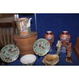 A pair of Japanese imari vases, a famille rose export ware teapot in a wicker basket, a pair of
