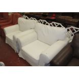 A pair of white upholstered armchairs