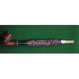 A 19th Century red lacquered and beaded pipe, 25cm long approx.