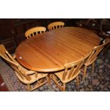 A pine pedestal dining table 160cm length, four chairs and another armchair Best Bid