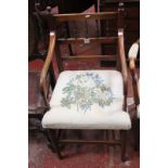 A 19th Century mahogany armchair with a spindle back and needlework seat