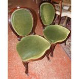 A set of four Victorian rosewood dining chairs with upholstered backs and seats