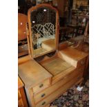 A 20th century dressing table with a central swing mirror flanked by drawers, raised on cabriole