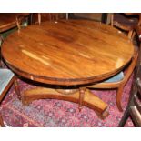 A William IV rosewood breakfast table with turned column on lapetted triform platform and scroll