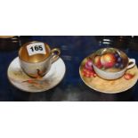 A Royal Worcester coffee cup and saucer painted with pheasants by J Stinton and another Royal