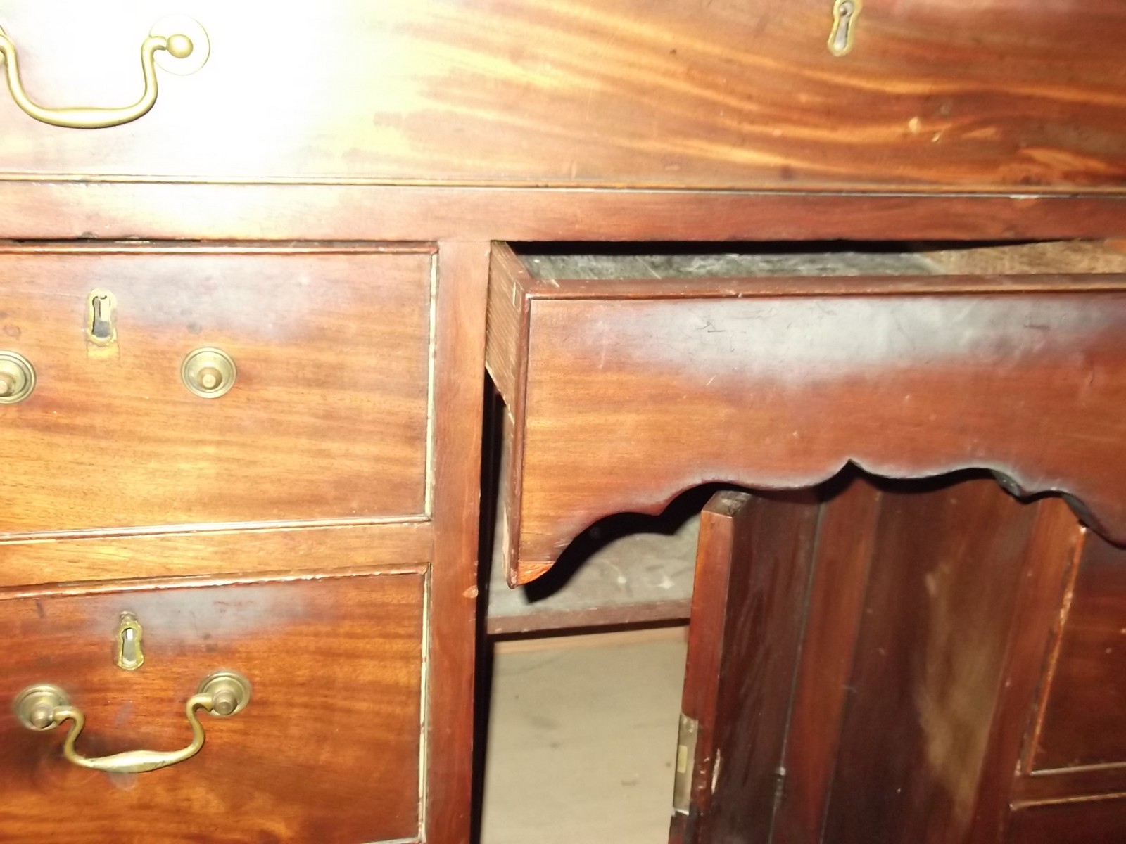 A George II mahogany kneehole desk circa 1740 with a rectangular top, six short drawers flanking a - Image 7 of 11