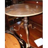 A George III mahogany tilt top table with circular top above turned pillar and tripod base, 68cm