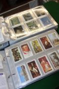 Two albums of cigarette cards to include Wills, Players, Brooke Bond and Odgens cricket 1926 and
