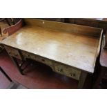 A Regency mahogany dressing table with gallery top above central frieze drawer and two flanking