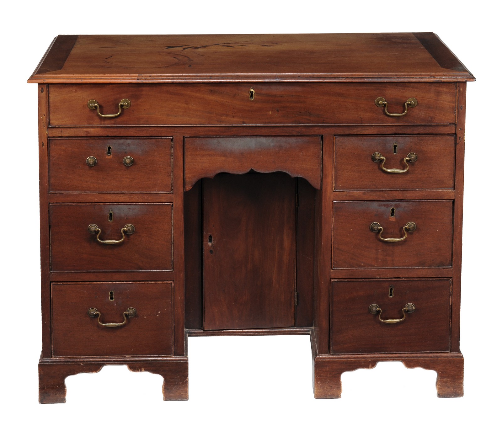 A George II mahogany kneehole desk circa 1740 with a rectangular top, six short drawers flanking a