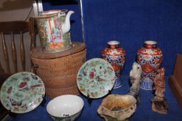 A pair of Japanese Imari vases, a famille rose export ware teapot in a wicker basket, a pair of