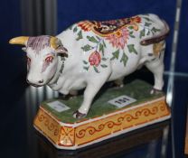 A Dutch Delft model of a polychrome cow, on a shaped rectangular base, circa 1900 Best Bid